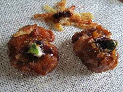 Buñuelos fritos de harina de espelta, rellenos con pera y pasta de almendra, y glaseados con miel y anís.